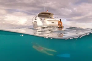 Divers entering the water from a charter boat