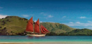 A sailing yacht under way off Komodo Island