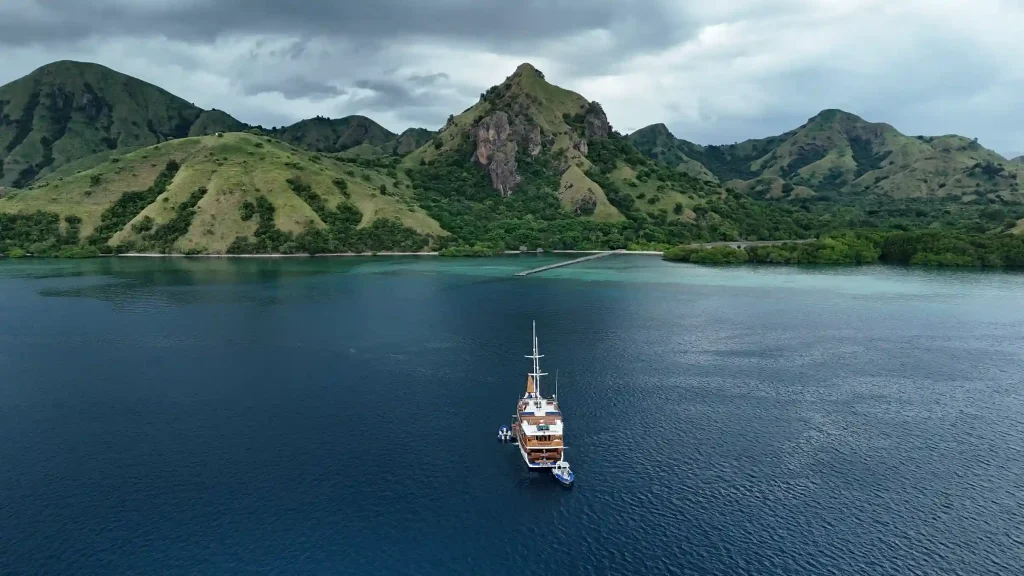 Traditional phinisi at anchor in a calm bay